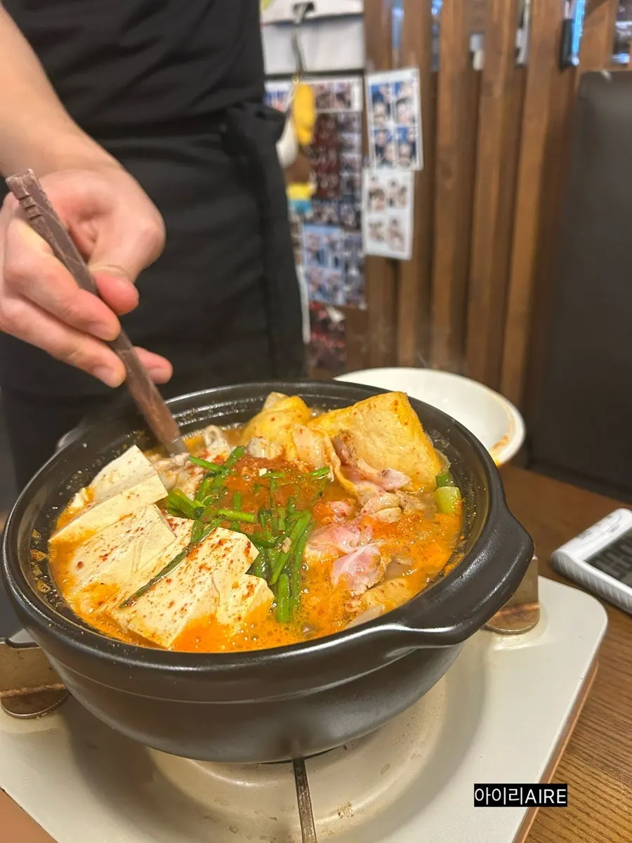 Earthenware pot filled with Korean beef gopchang and vegetables