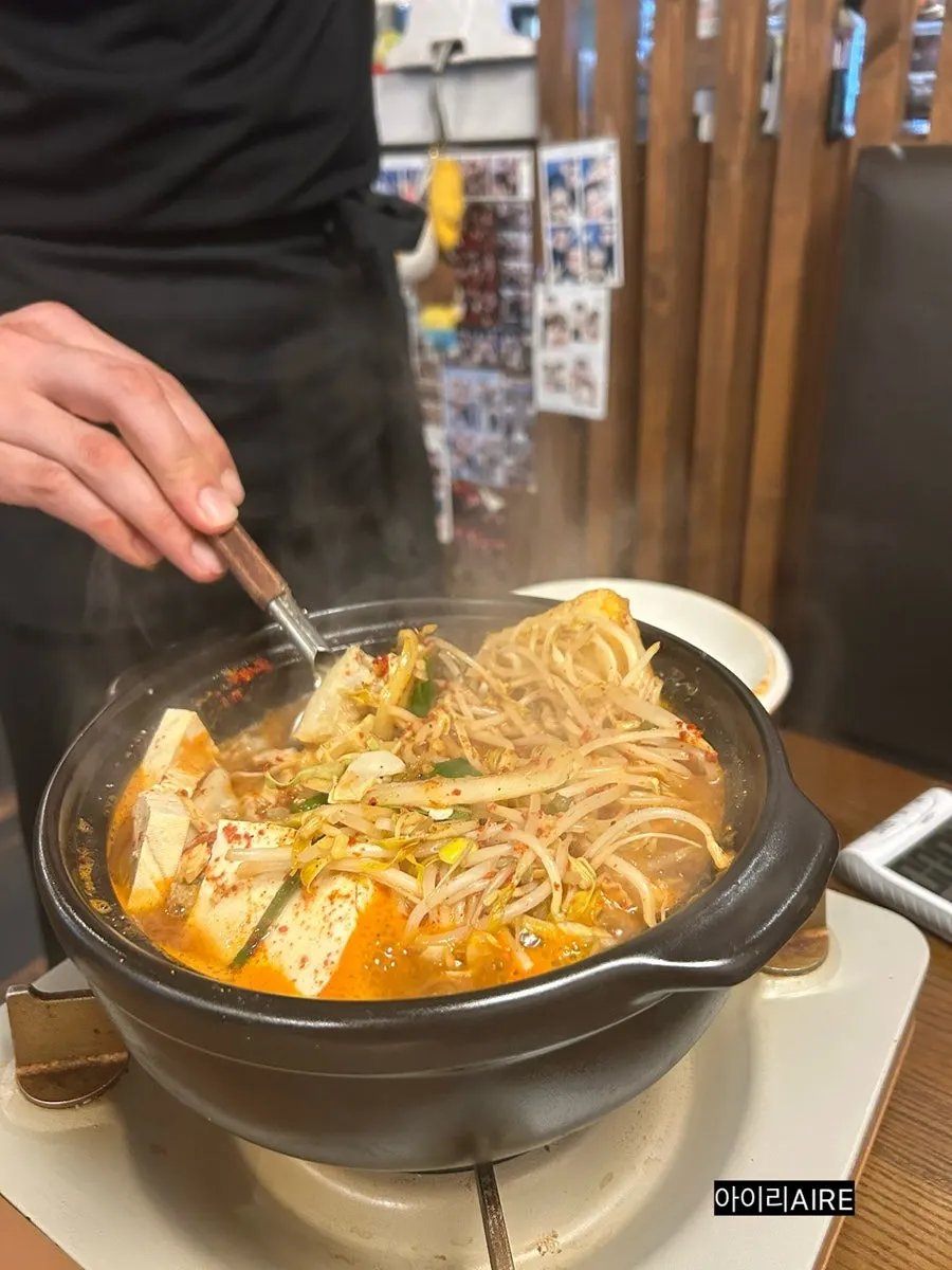 Opened lid of the gopchang hot pot with yuzu soy sauce