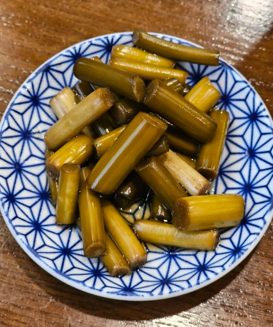 Complimentary garlic scapes and yuzu soy sauce