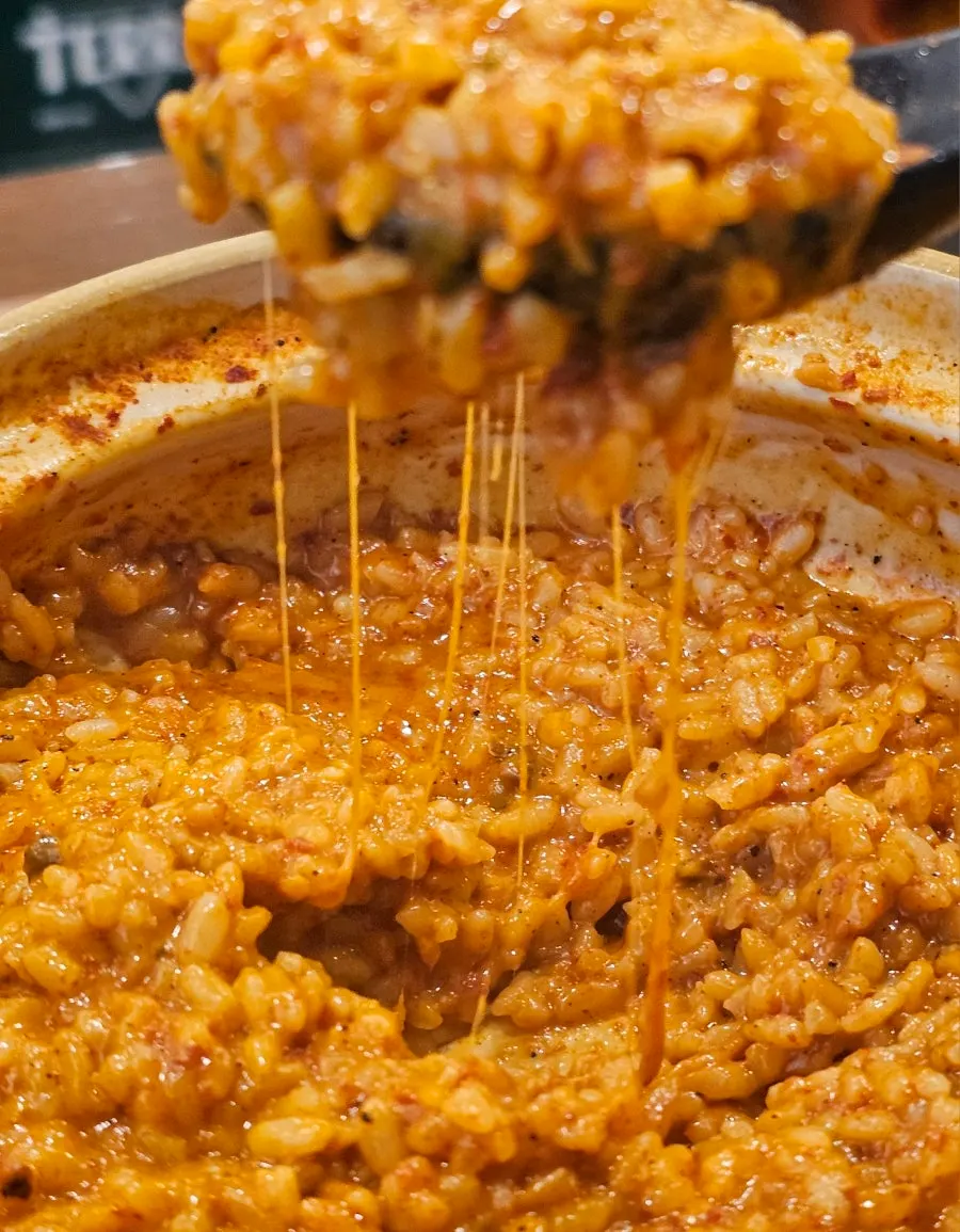 Cheese stretching from the cheese risotto