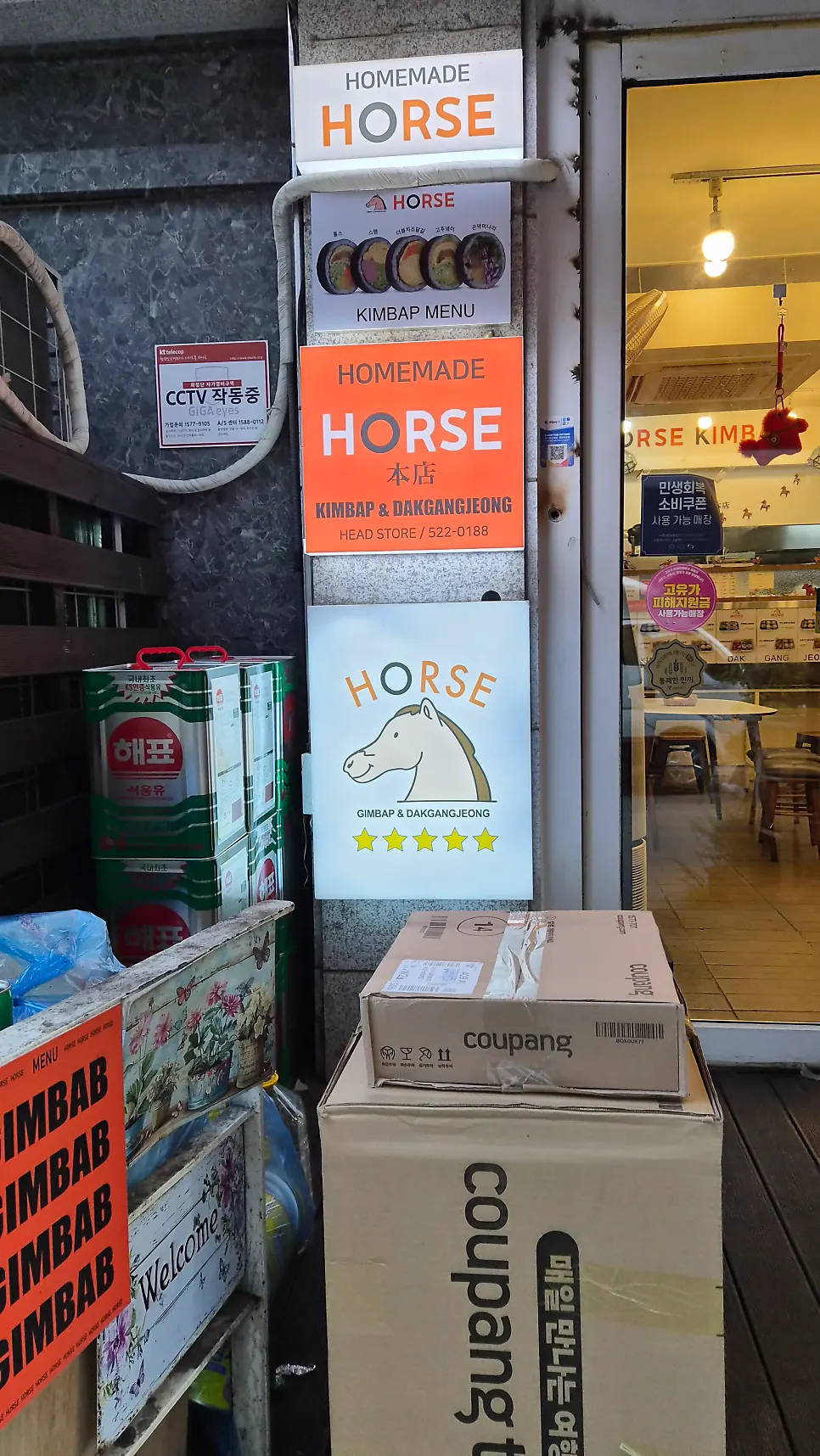 Horse logo sign and menu board next to the entrance