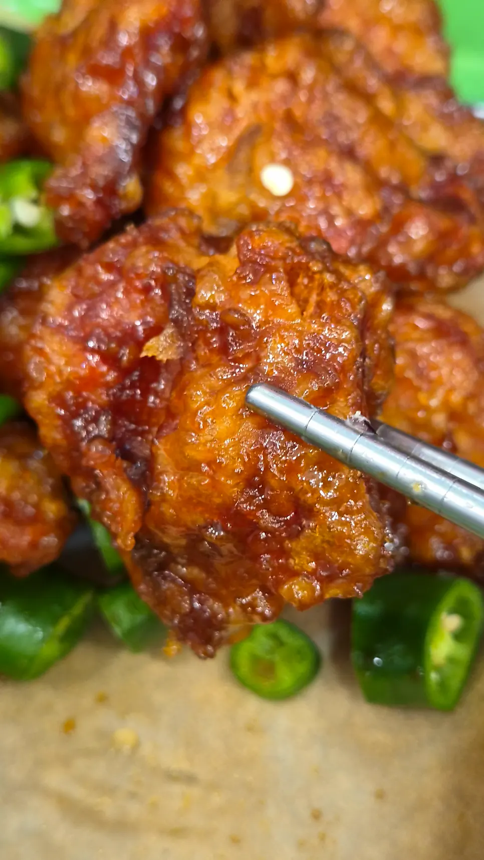 Close-up of a sauce-coated dakgangjeong piece