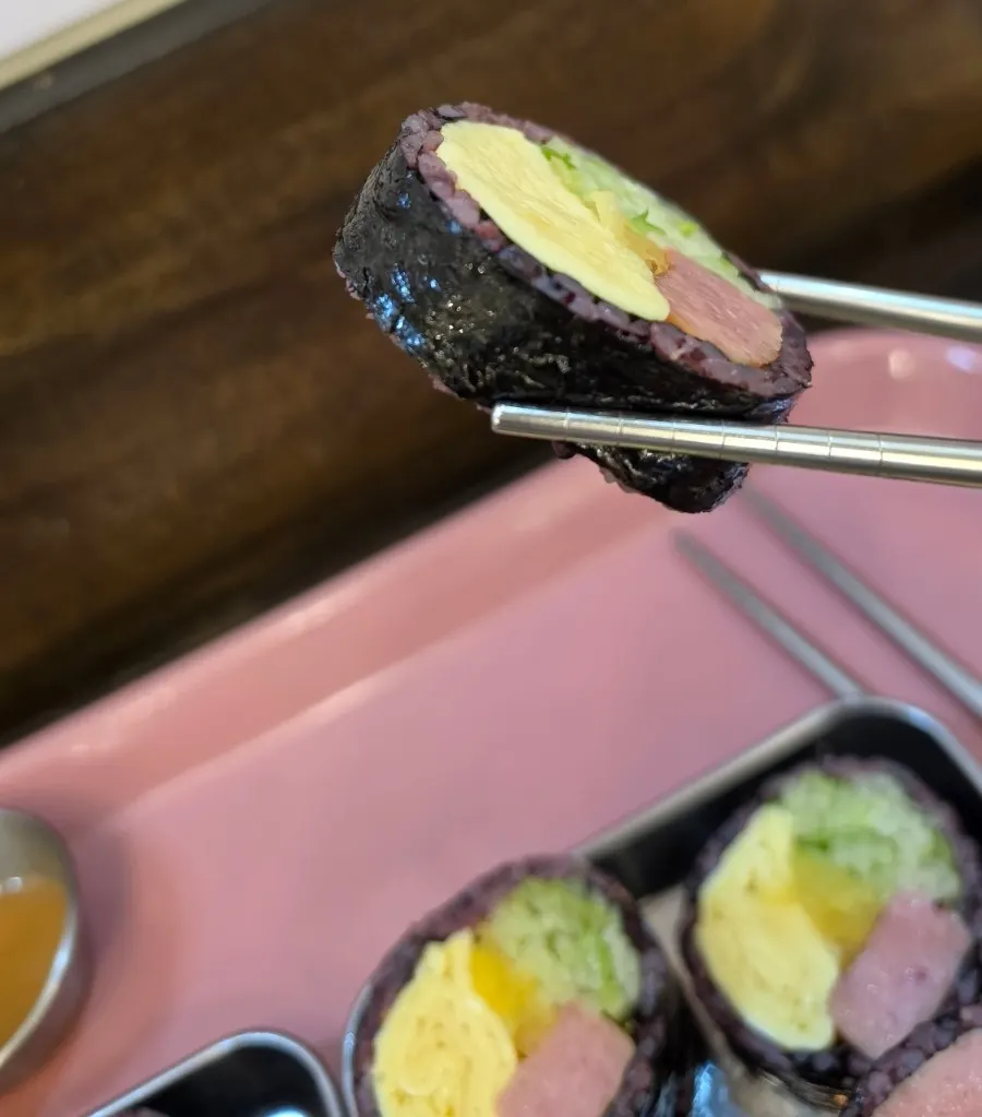 Spam gimbap showing thick egg and cucumber