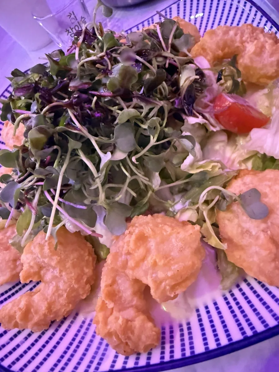 A plate of mango cream shrimp topped with mango sauce