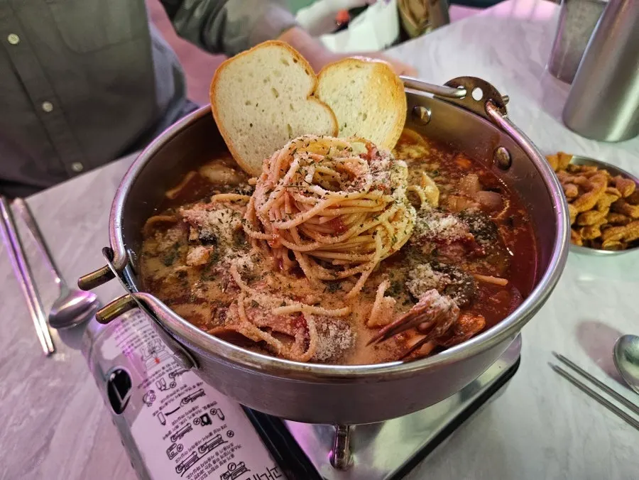 Close-up of tomato broth and pasta noodles