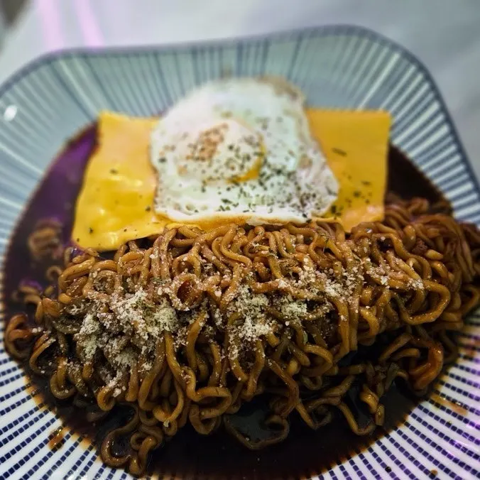 Jjagyechi topped with fried egg and cheese