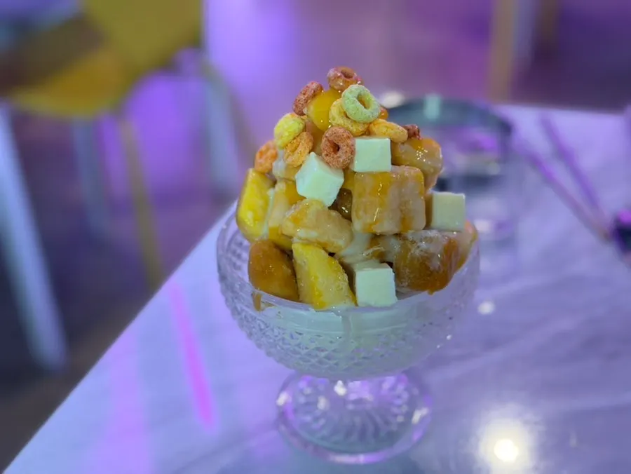 A spoonful of mango bingsu scooped out