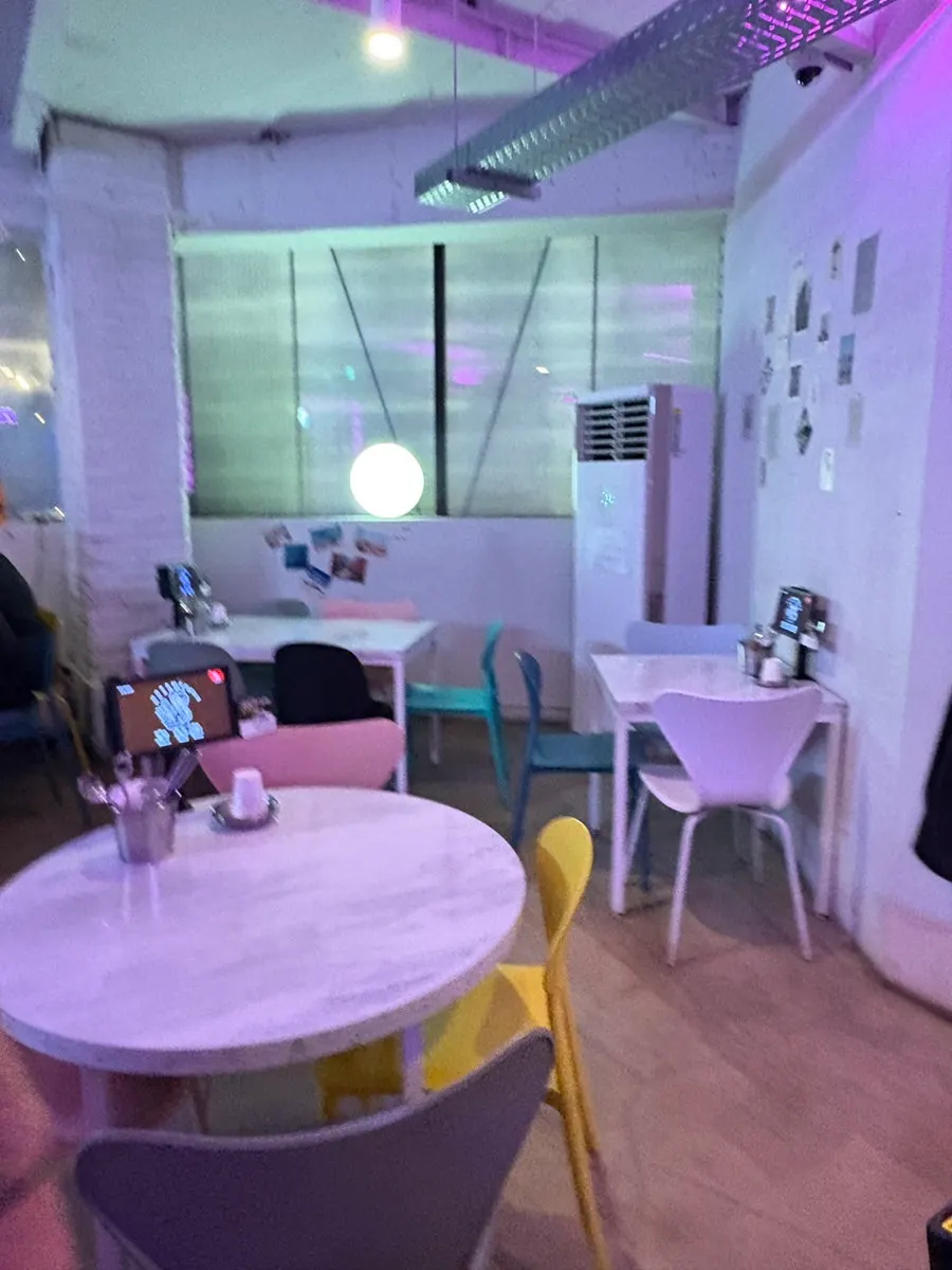 Table seating under pink lighting at Ho Samchon