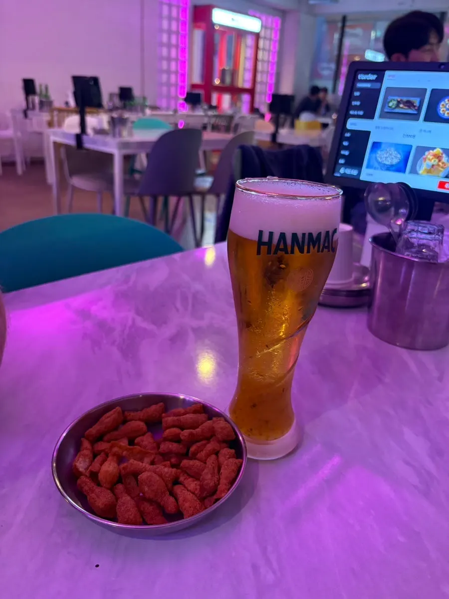 A glass of Ho Samchon's citrus beer with citrus syrup at the bottom