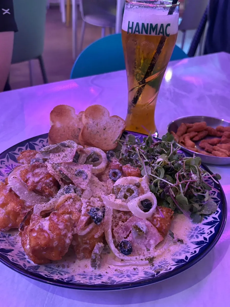 Close-up of chicken topped with carbonara sauce