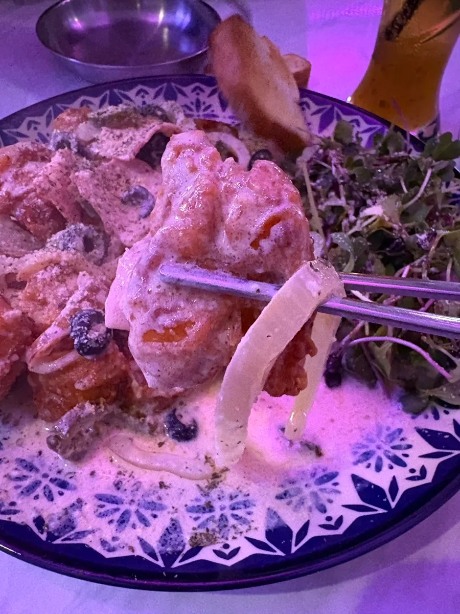 Carbo chicken piled high with onion and olives
