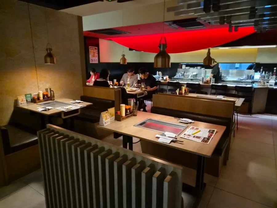 Dim interior hall of Hotcho with lighting focused on each table