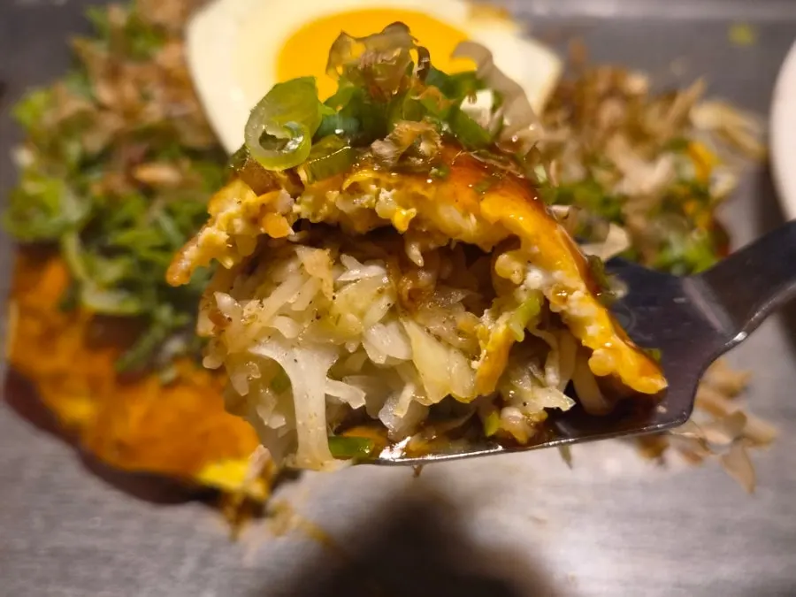Cross-section of the okonomiyaki packed with cabbage and meat