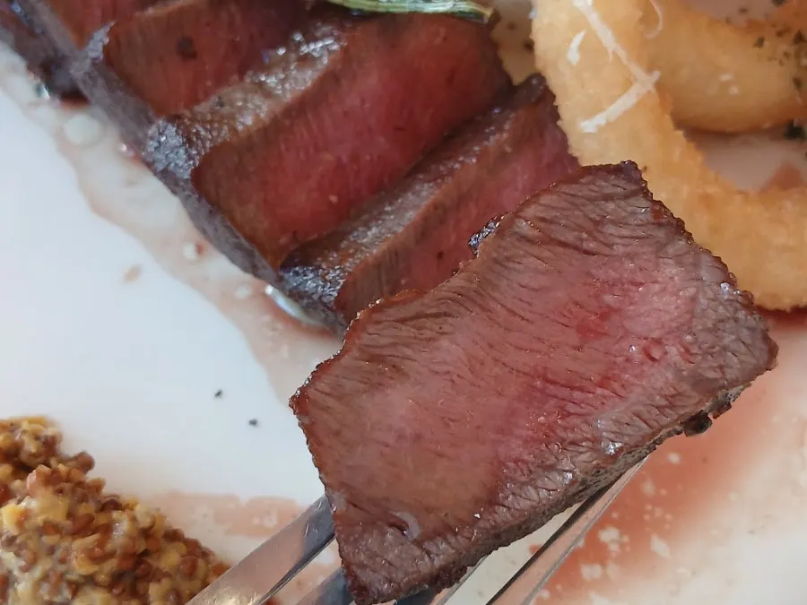 Cross-section of the house steak cut into bite-sized pieces