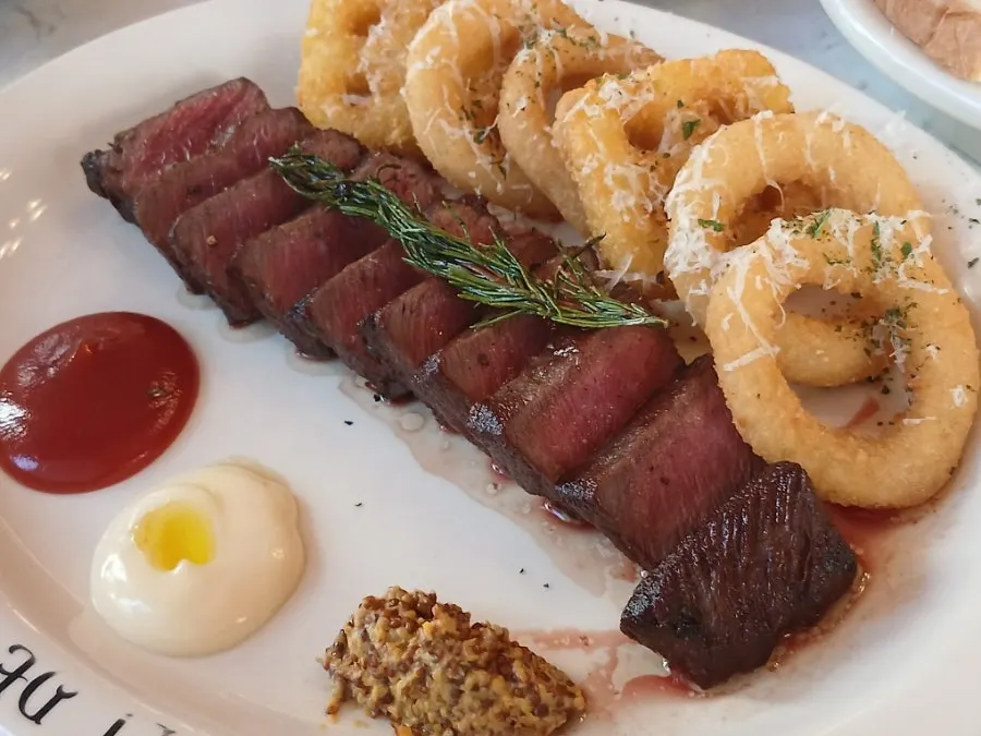Plate of house steak partway through the meal