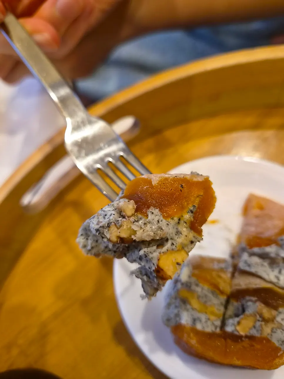 Cross-section of persimmon with black sesame cream and walnuts