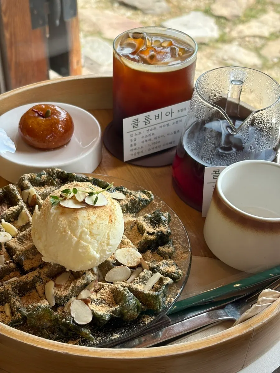 Spread of gaeseongjuak, injeolmi waffle, and coffee on the table