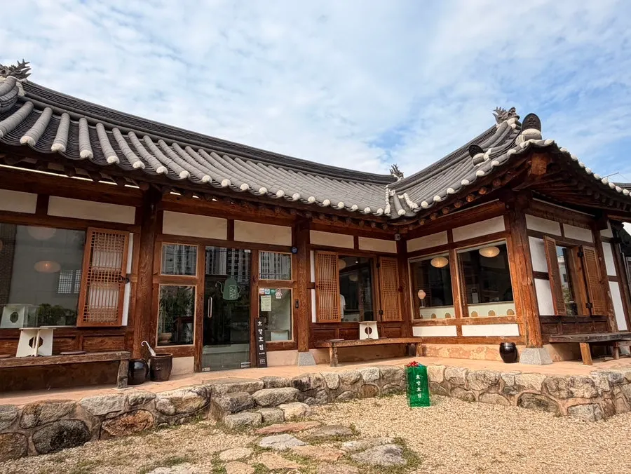 Courtyard and tiled-roof hanok visible past the gate of Hoyang Horim