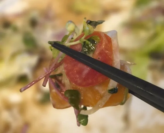 Salmon salad topped with thick slices of salmon