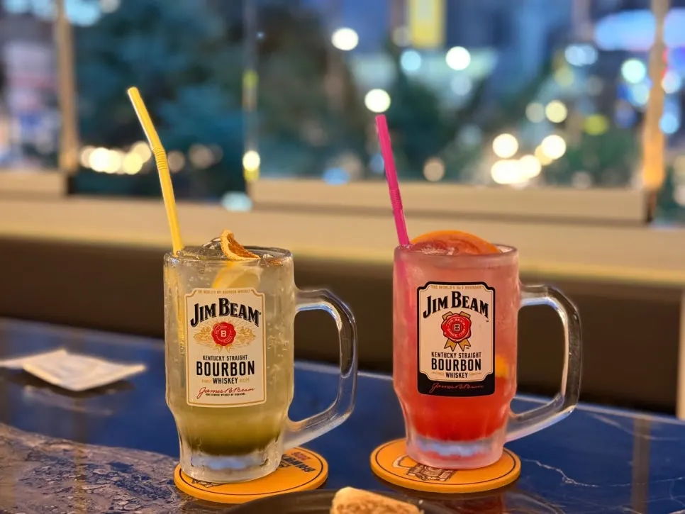 Two Jim Beam highballs with green grape and grapefruit base
