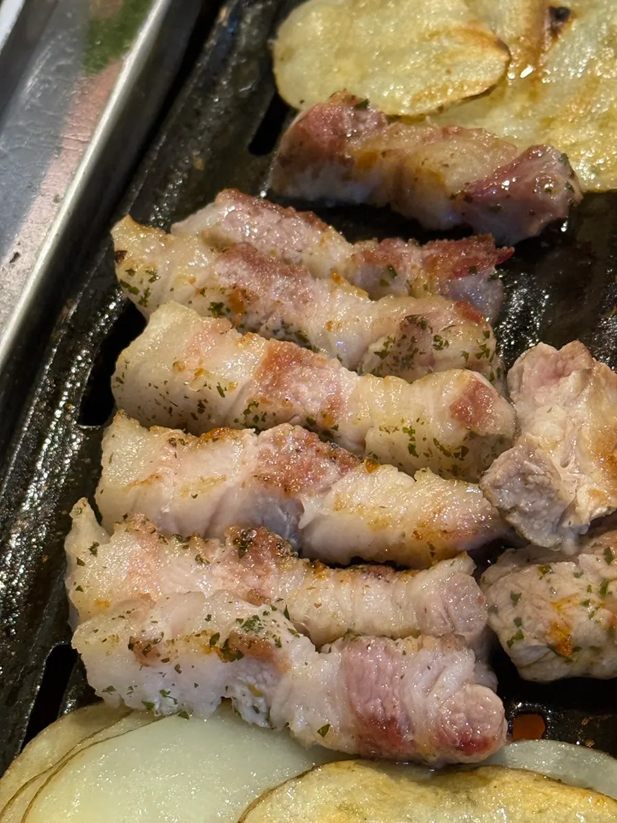 Staff member grilling the meat