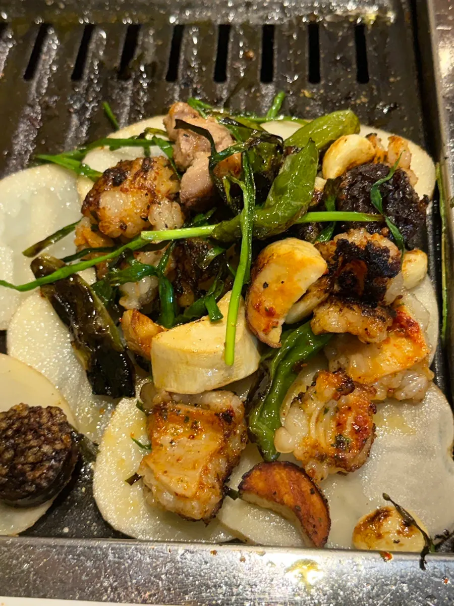 Grilled meat placed on top of potatoes
