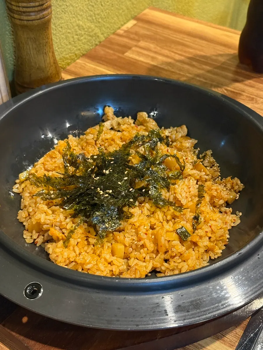 A bite of meat wrapped in shredded scallions