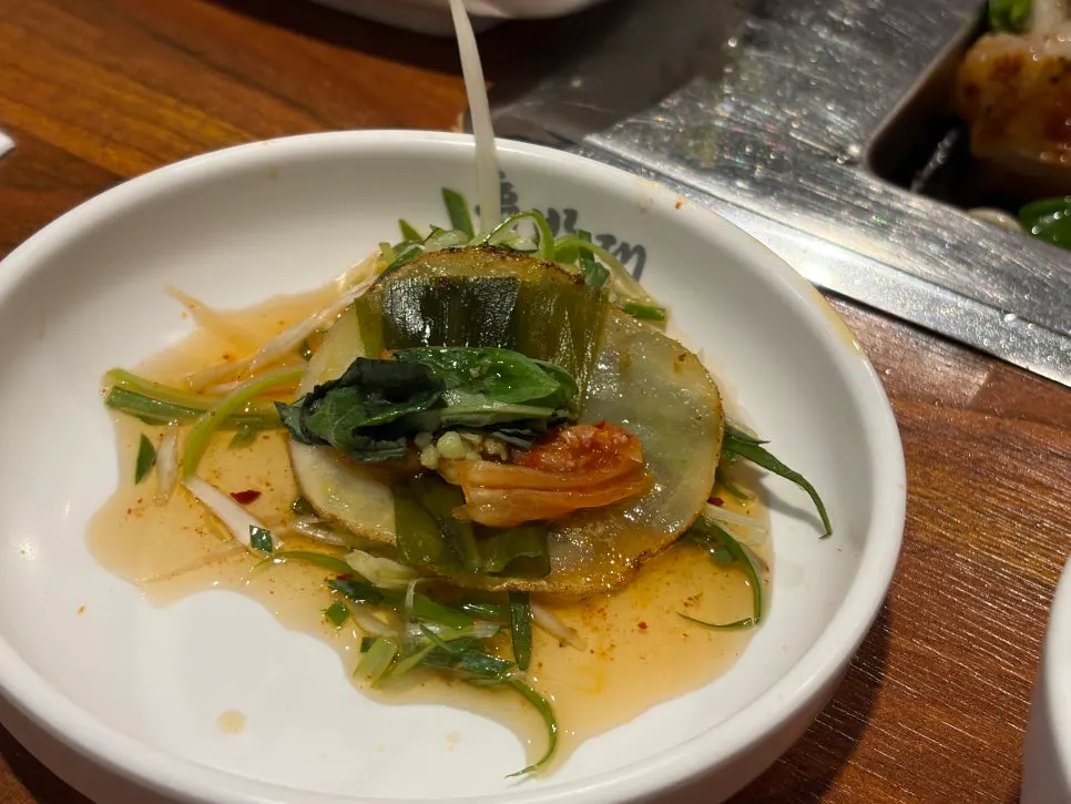 A wrap showing how to eat with basil on top