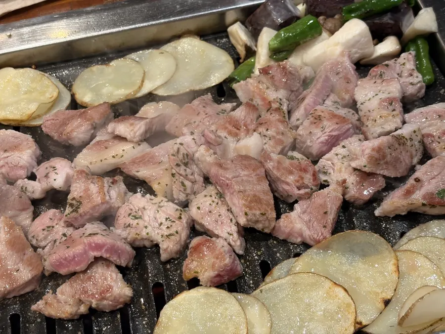 Staff grilling pork neck and honey potato