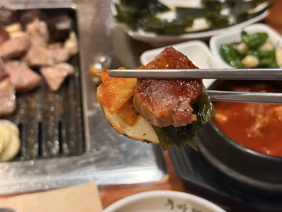 Honey potato, wild garlic leaves, spicy kimchi, fresh wasabi, and pork neck combination