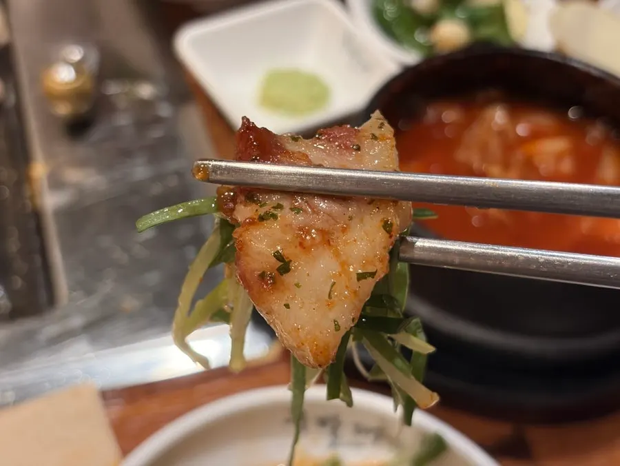 A piece of pork neck placed on honey potato