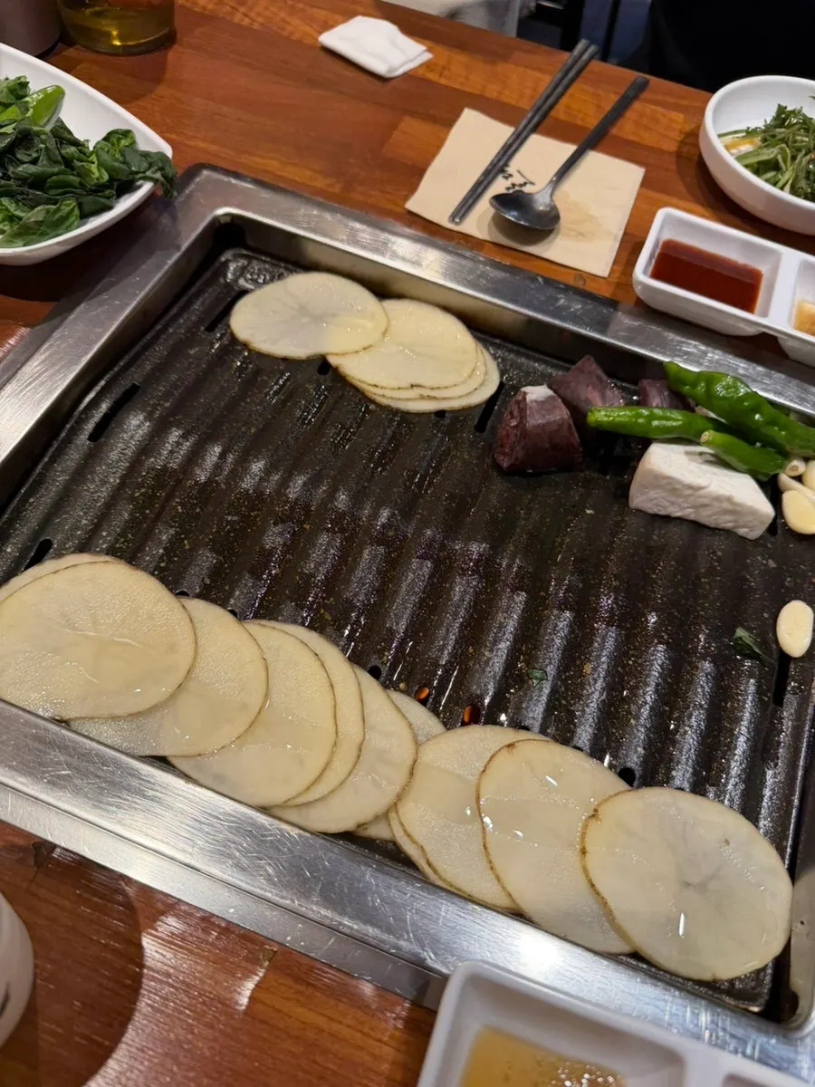 Staff member grilling the pork belly