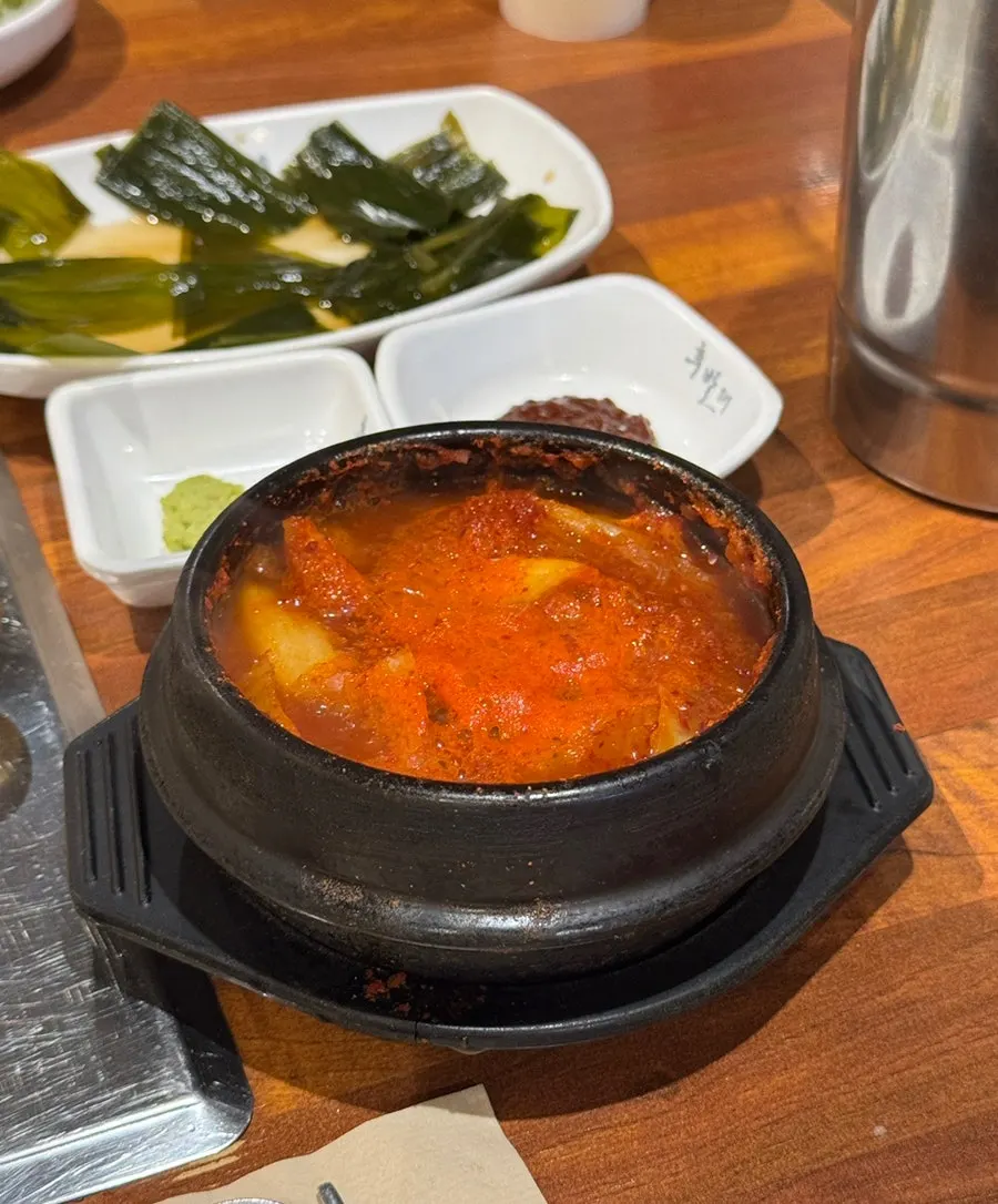 Pot of kimchi jjaglee served alongside the meal