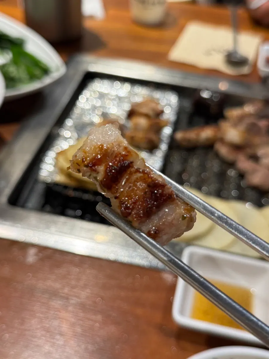 Finished meat and side items on the grill