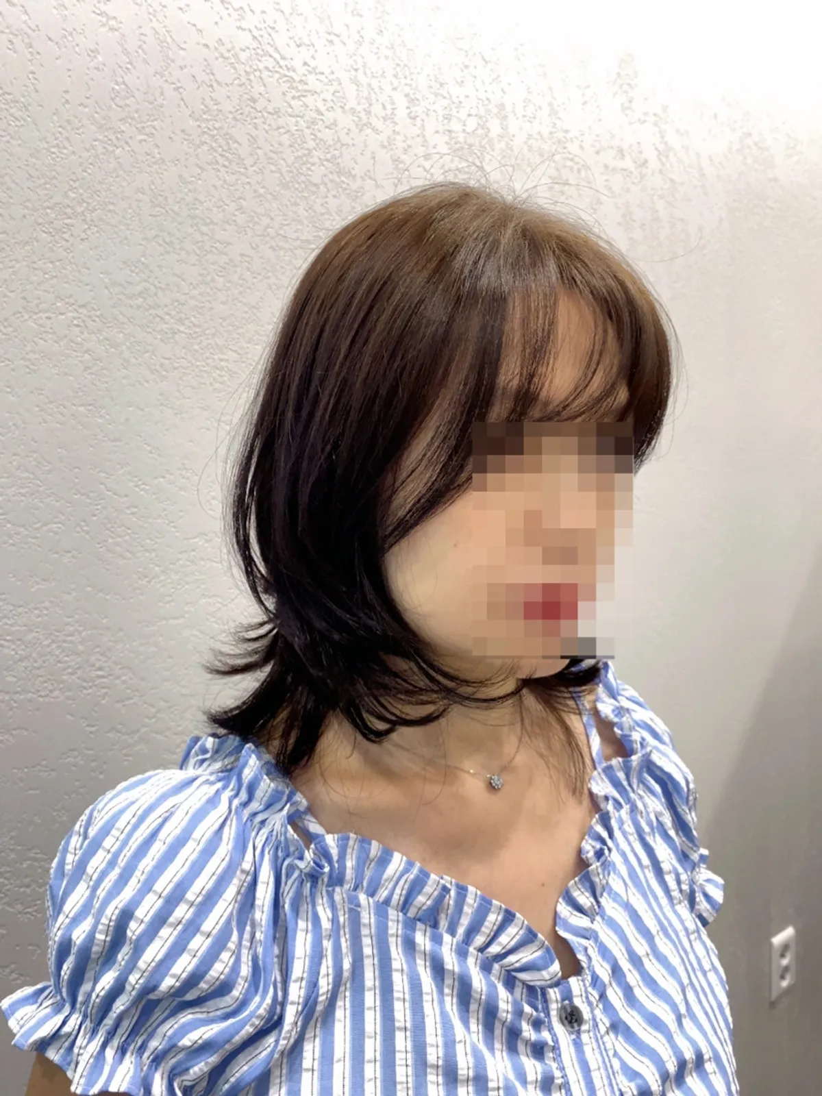 Finished mid-length layered cut with bangs down