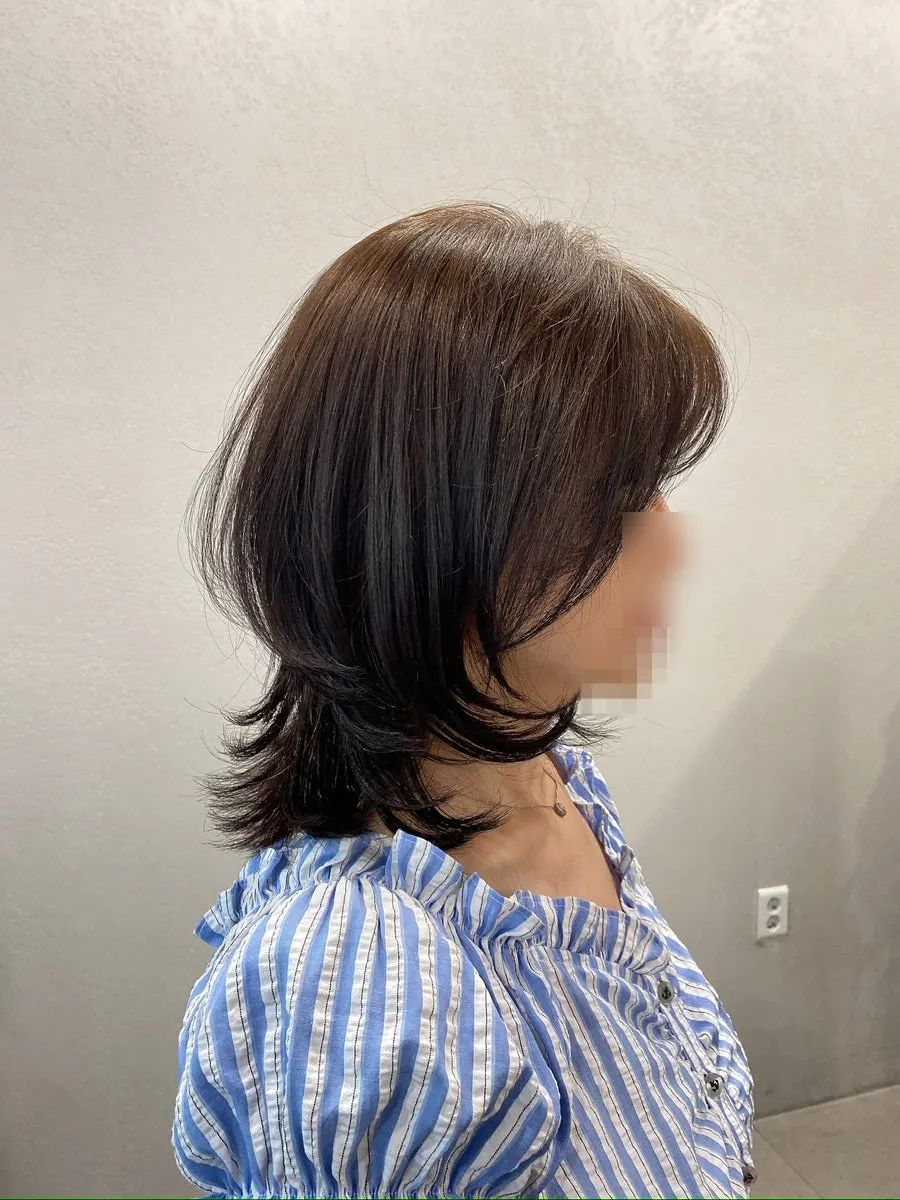 Bangs and layered lines complementing the face shape