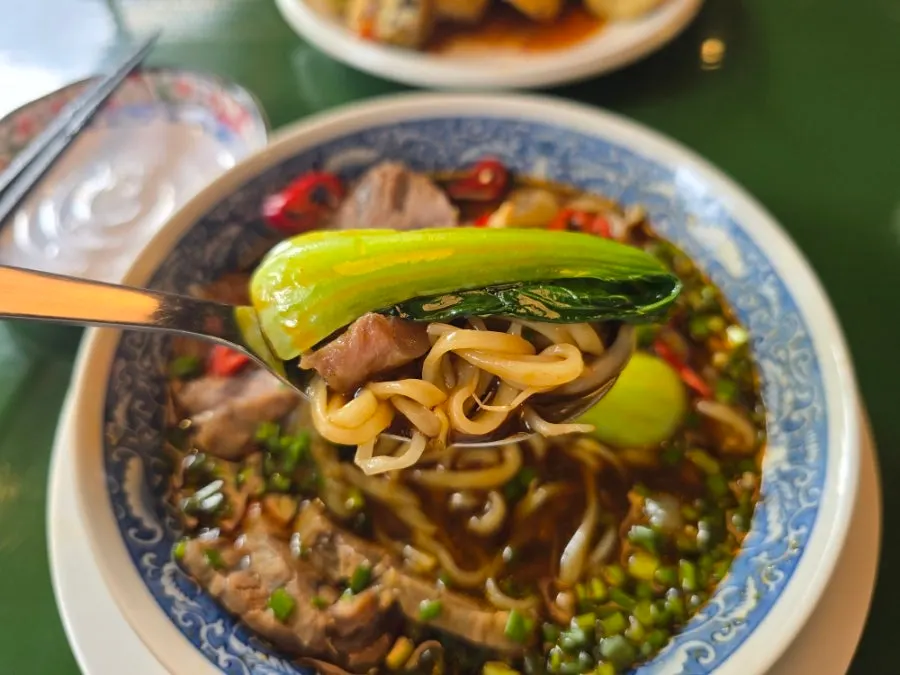 Huhugwan's beef noodle soup topped generously with meat