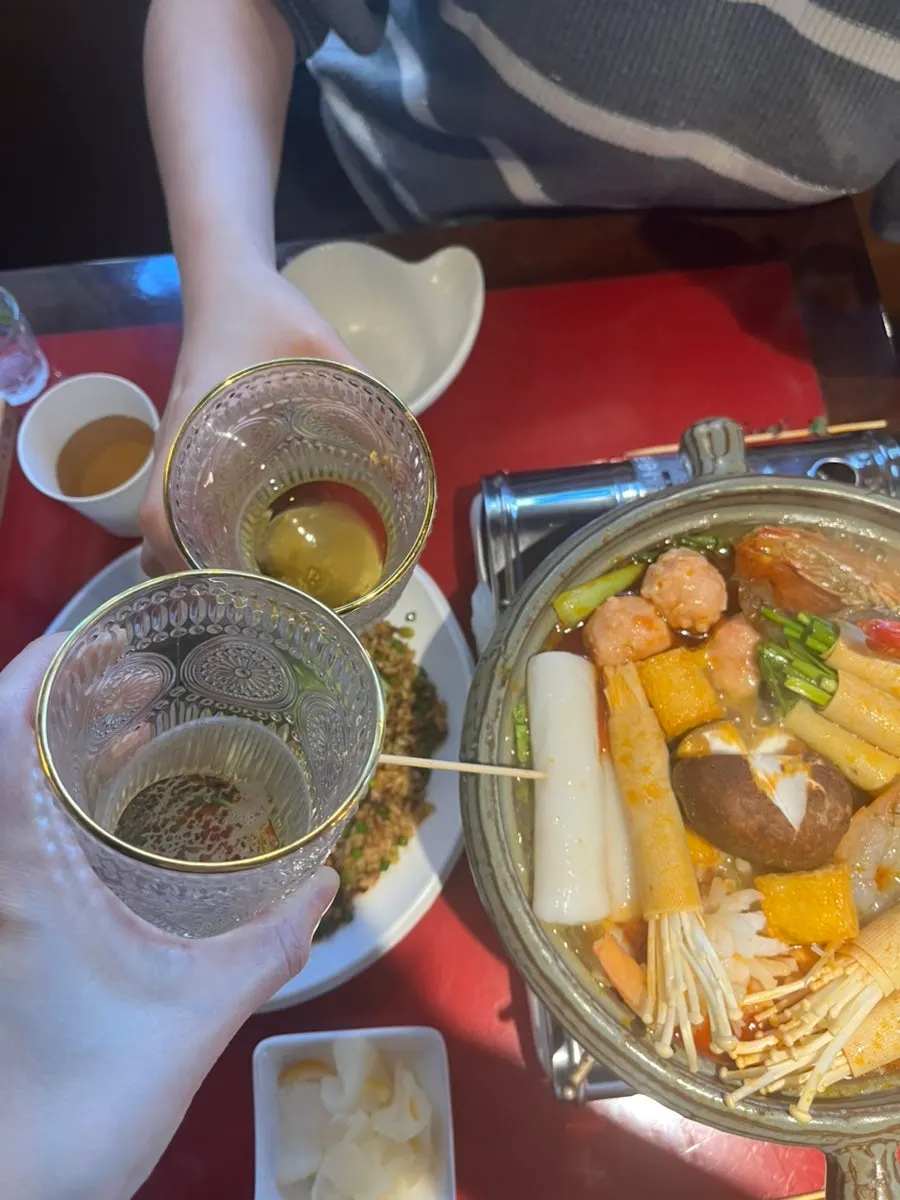 A glass of somaek enjoyed with the mala hot pot