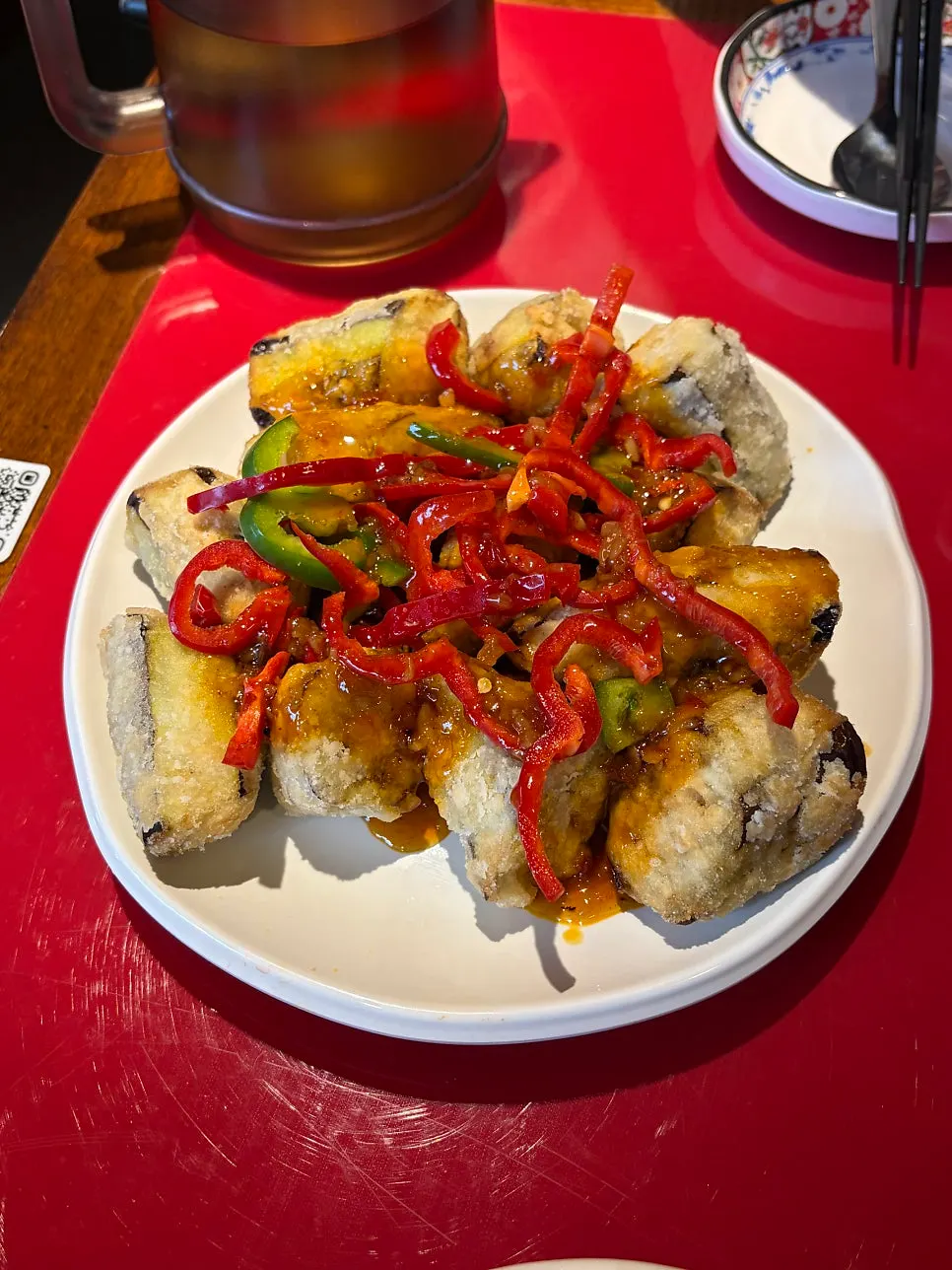 A plate piled high with fried eggplant at Huhugwan
