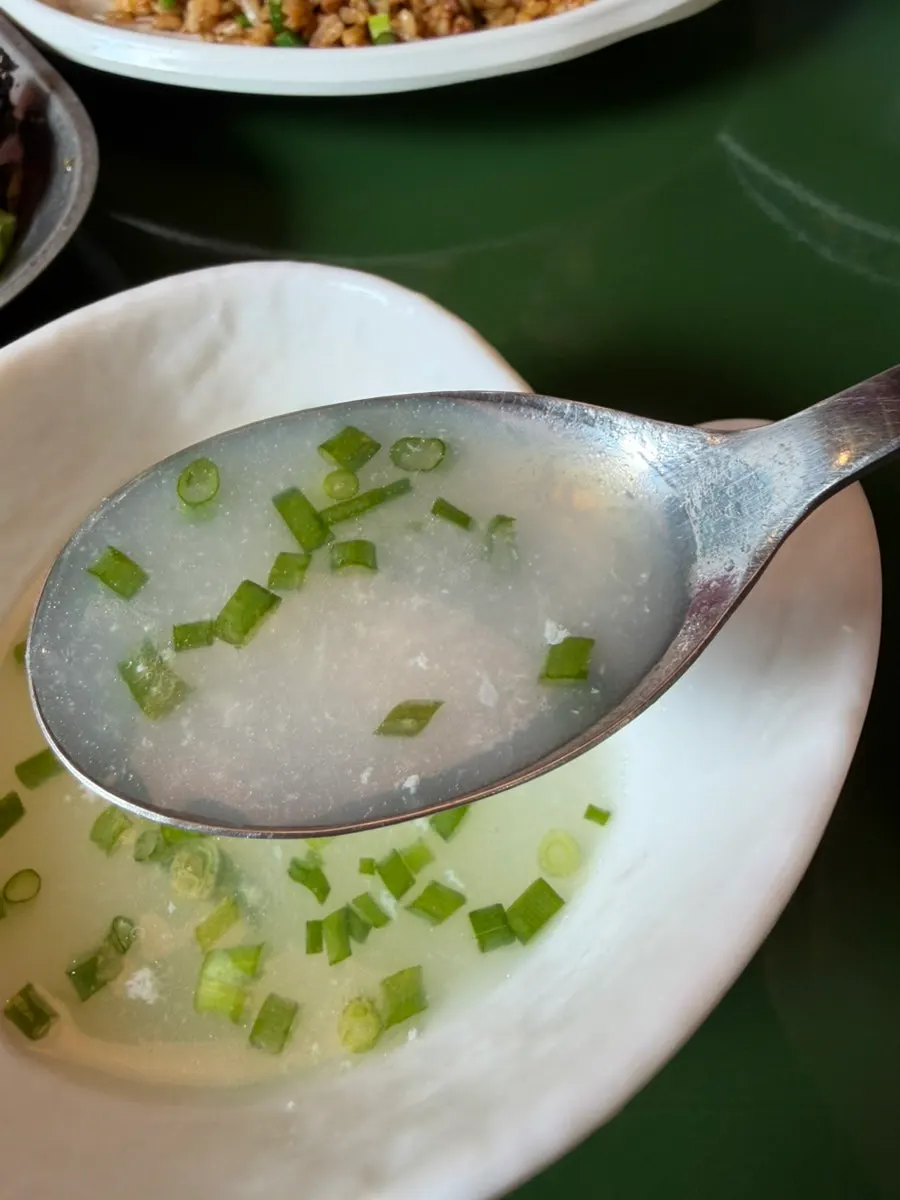 A spoonful of fried rice with crunchy garlic scapes