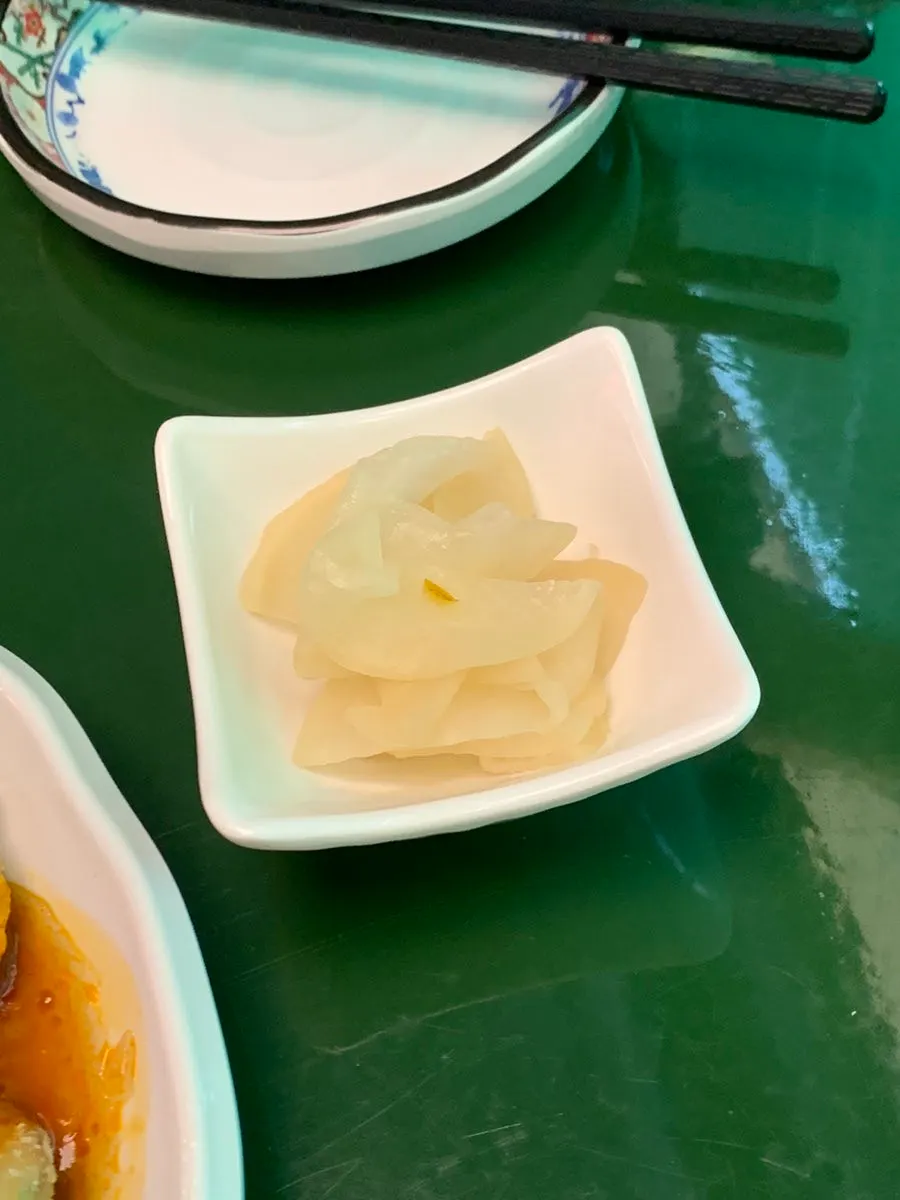 Tea served instead of water, with pickled radish