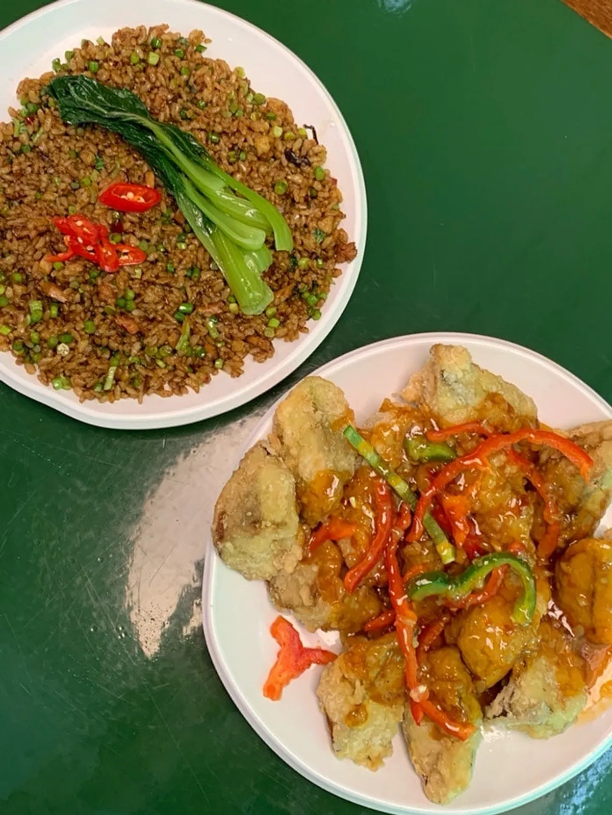 Table spread of eggplant fritters and mala chaofan