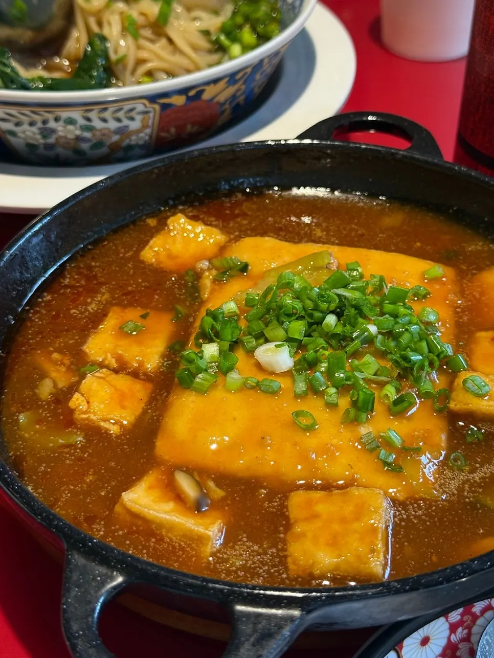 Scooping up Huhugwan's mapo tofu with a spoon