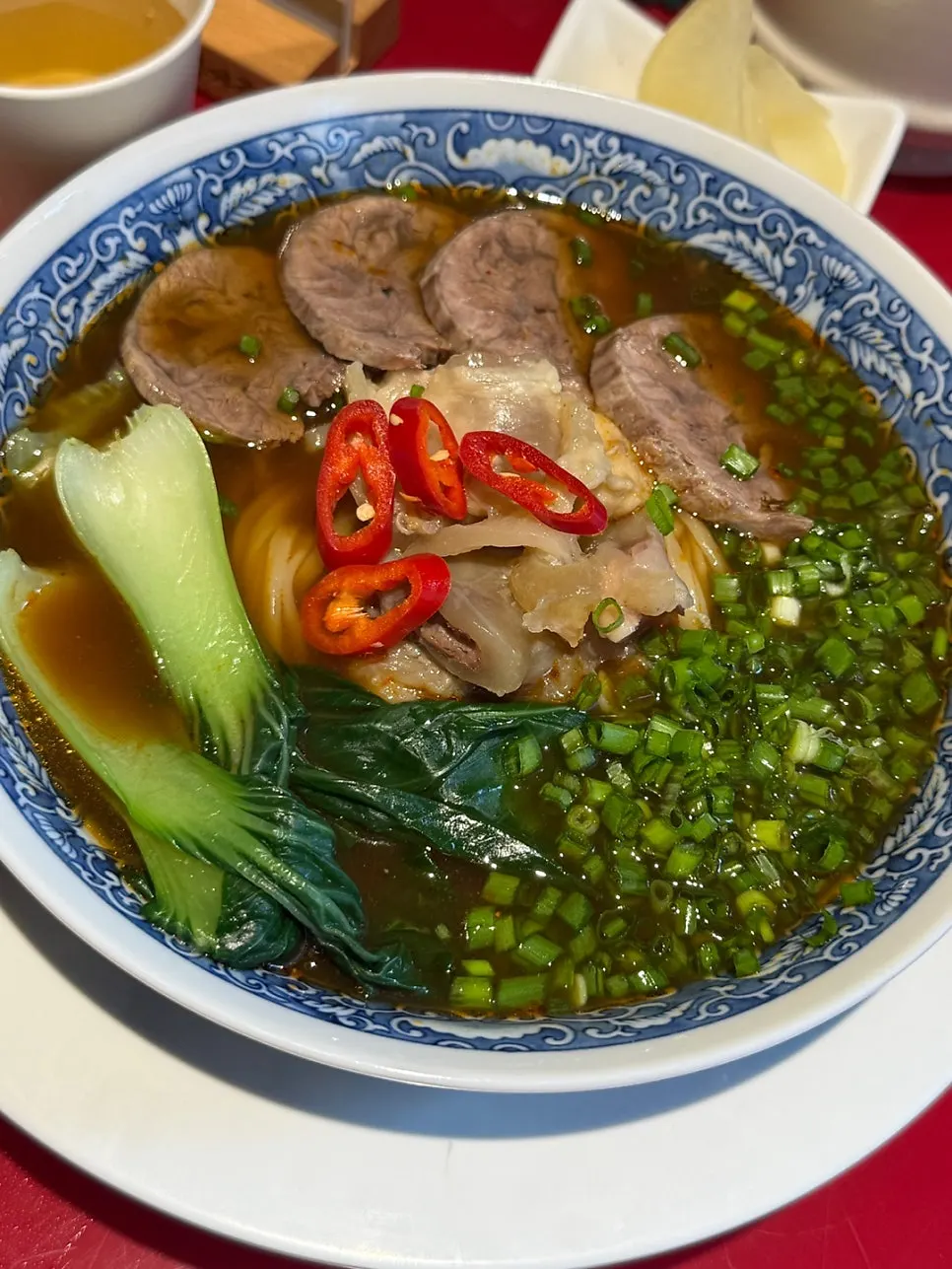 Broth and noodles coming together in Huhugwan's beef noodle soup