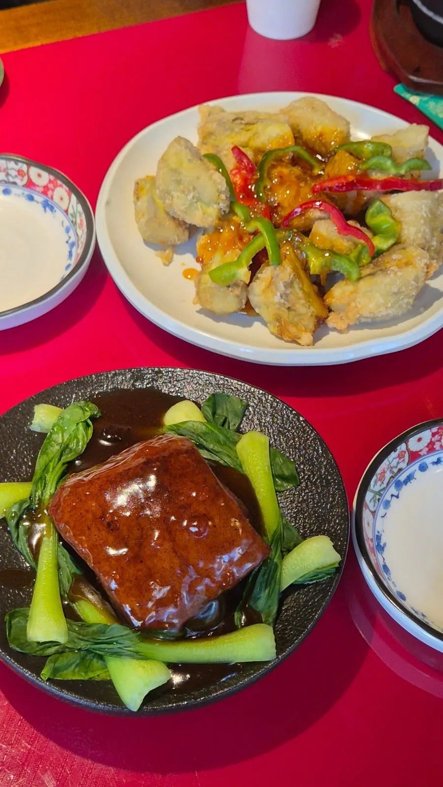 Eggplant fritters and braised pork belly set on the table