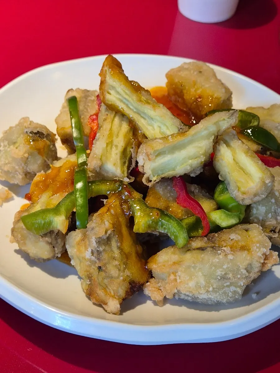 Cross-section of eggplant fritter torn along the grain