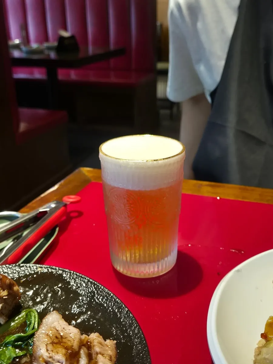 Eggplant fritters with a glass of Tsingtao draft beer