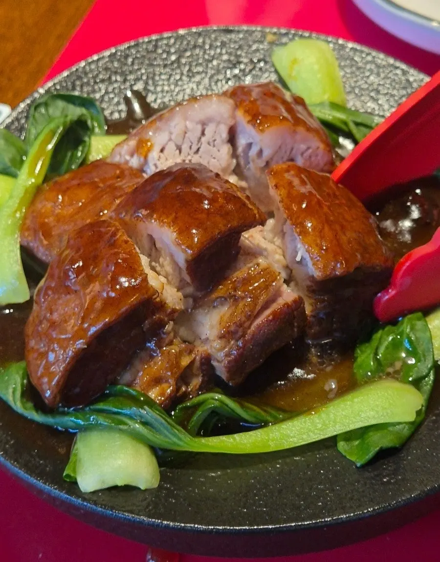 A plate of braised pork belly in brown sauce