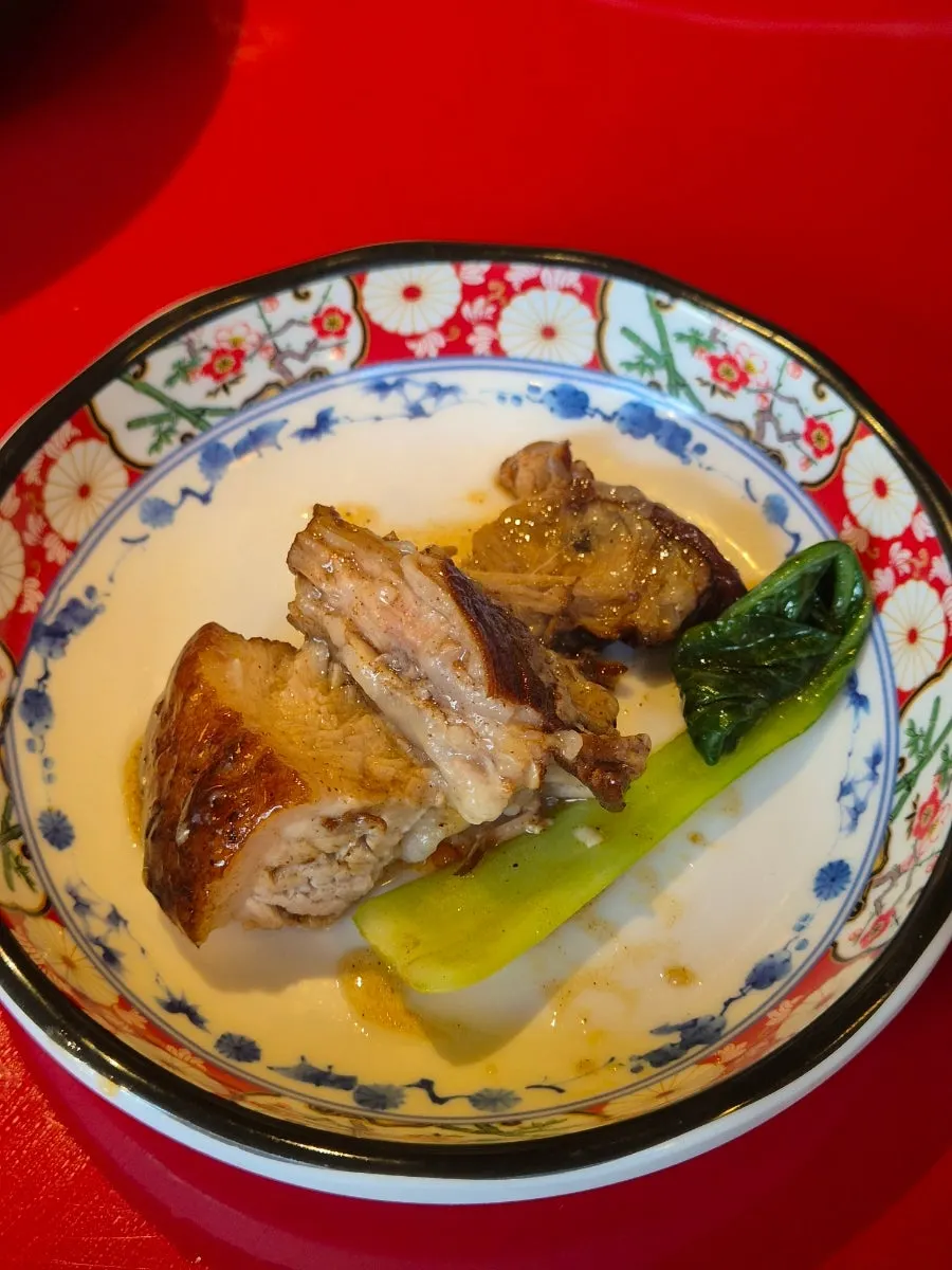 Cross-section of braised pork belly cut with scissors