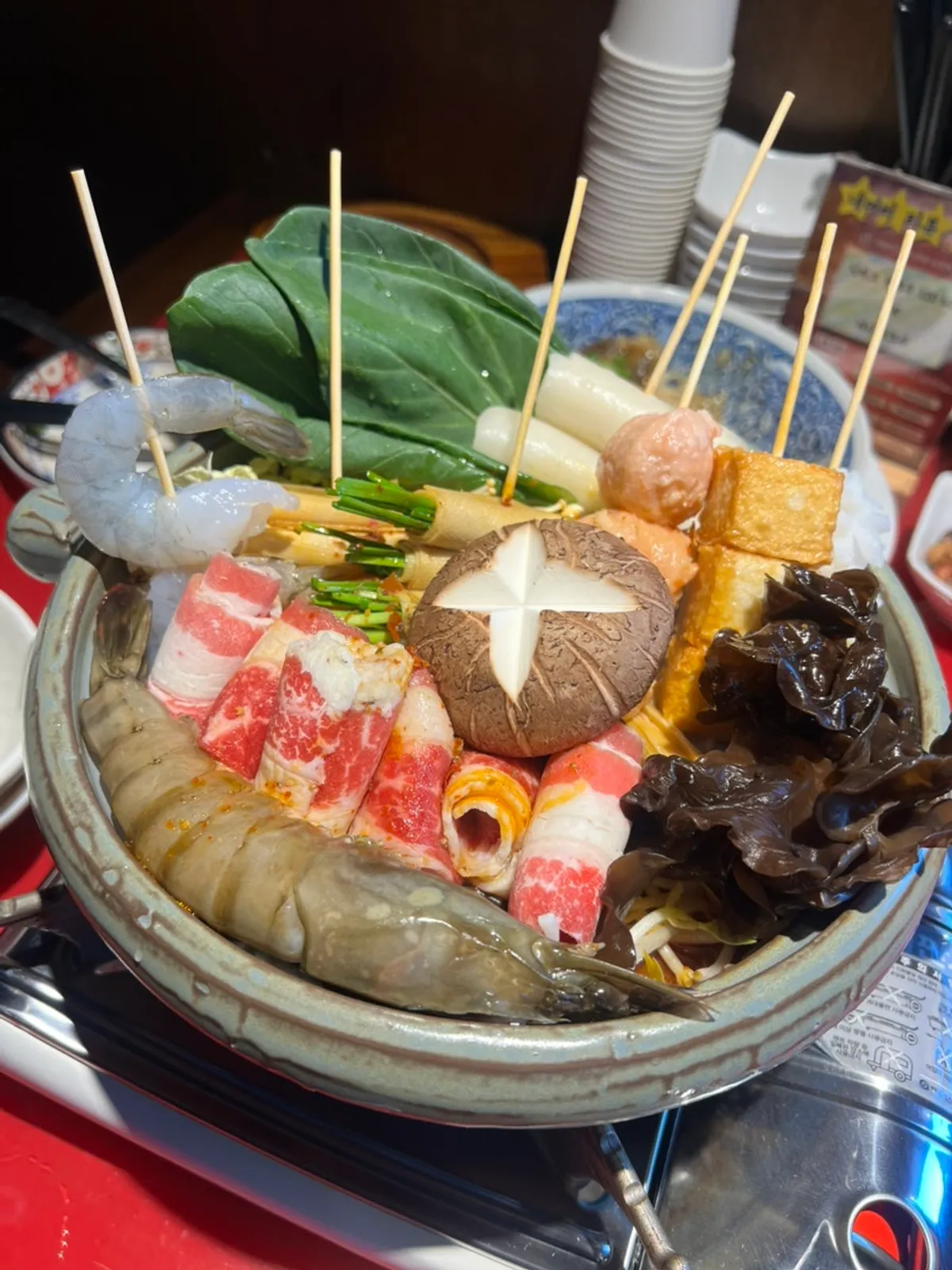 Huhugwan's mala hot pot table setup with king prawns and skewers